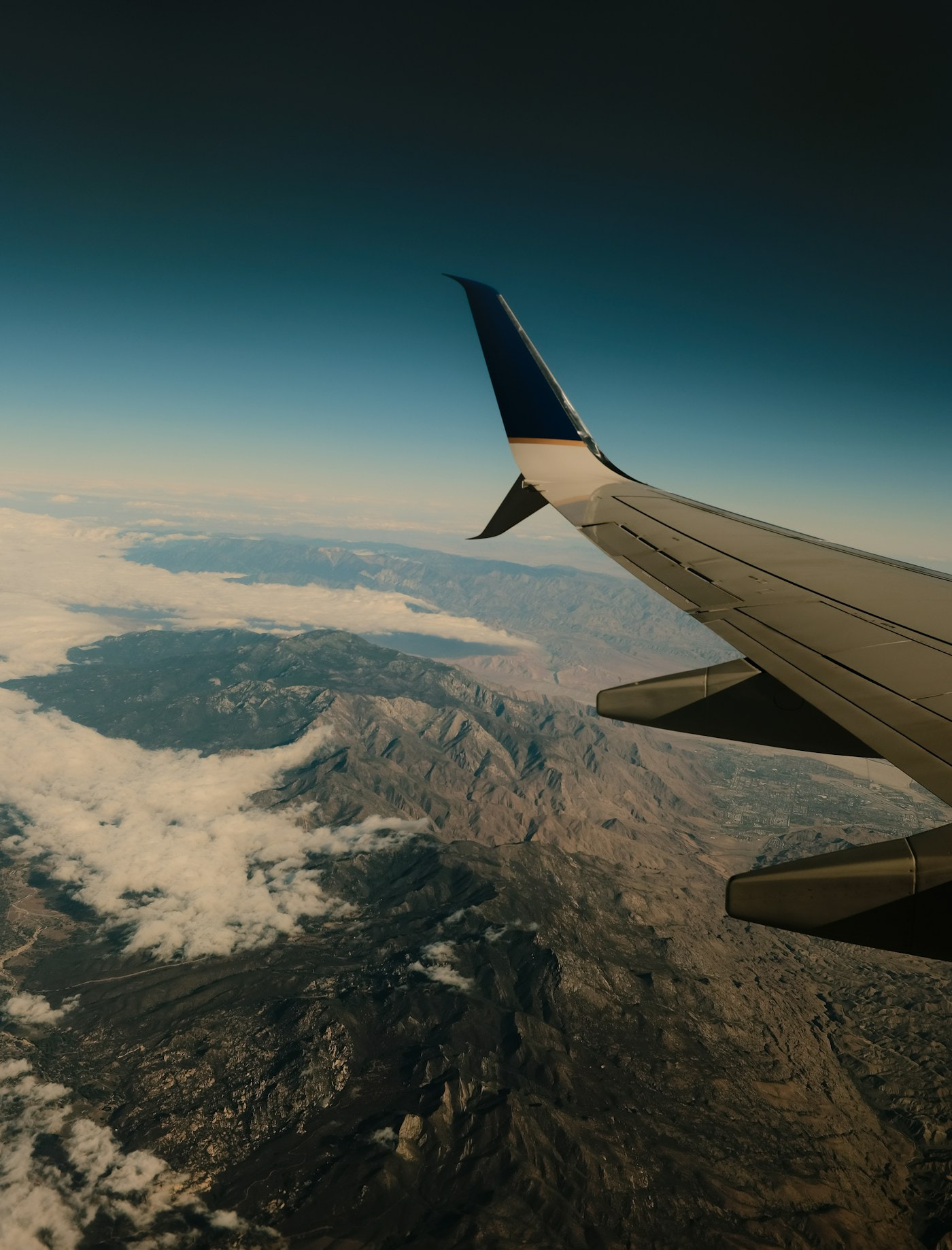 Aircraft wing and window view in flight, illustrative aviation photo