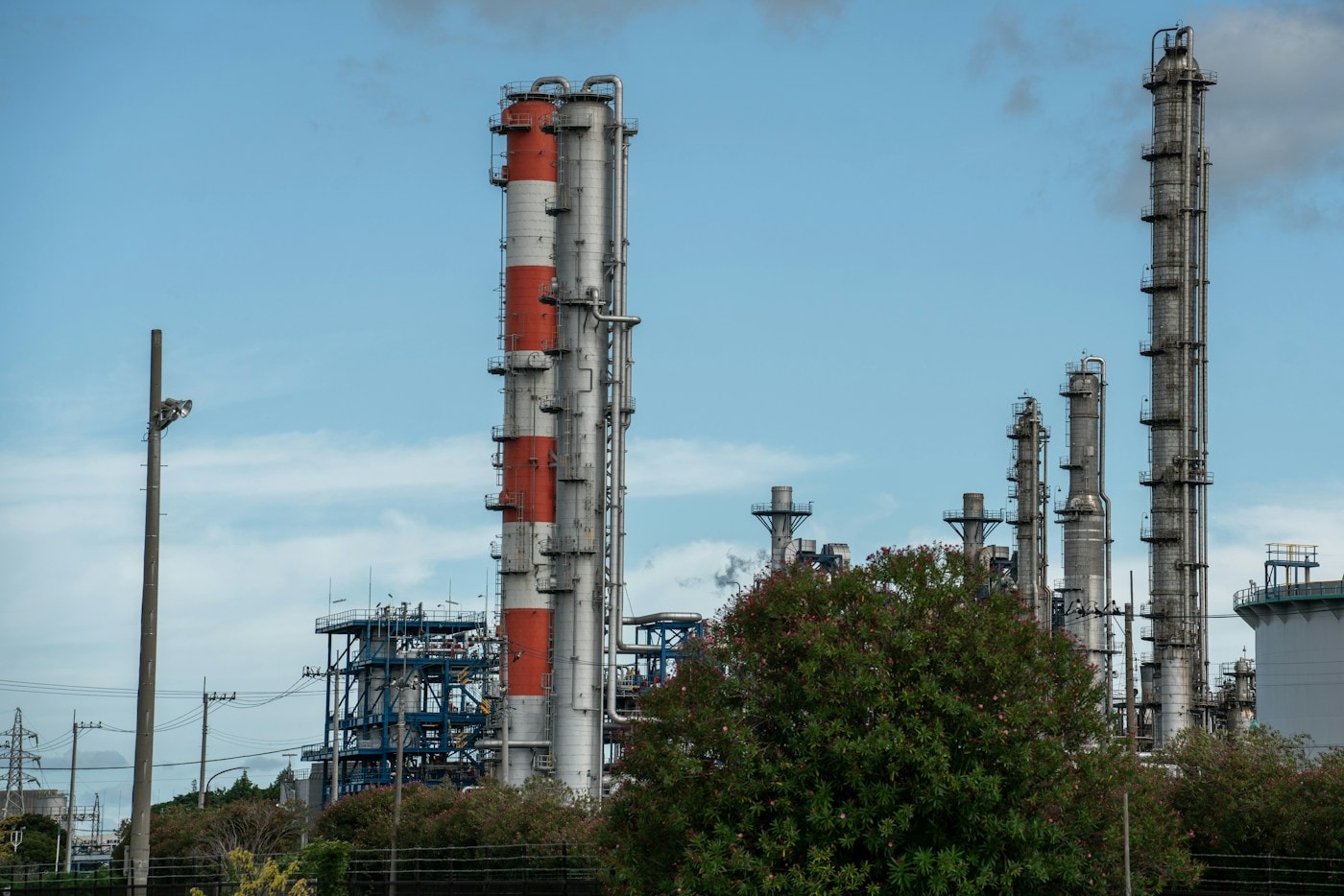 Refinery equipment under a blue sky, illustrative industry photo